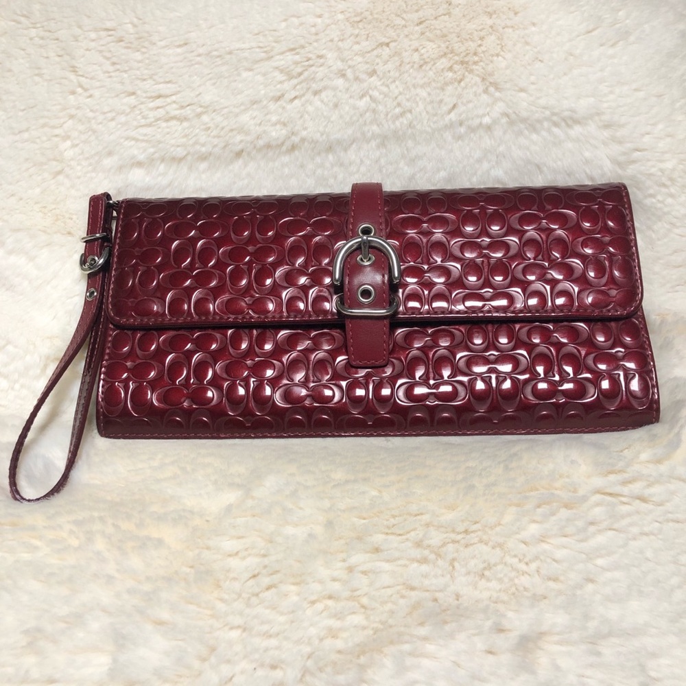 Coach logo embossed patent leather clutch